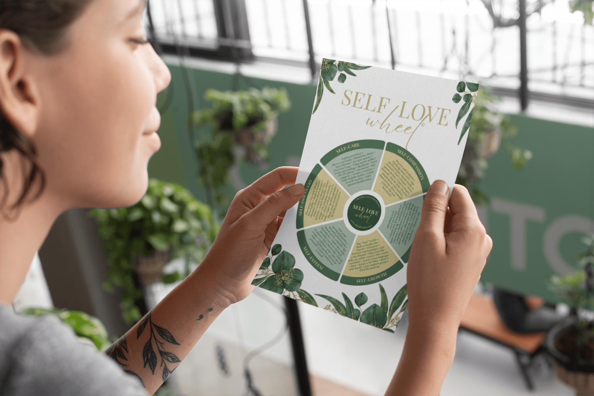 A woman holding the Self-Love Wheel